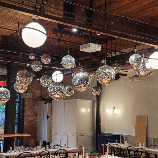 A cluster of Disco Balls (a.k.a. Mirror Balls) suspended above the dance floor inside The Wythe Hotel.