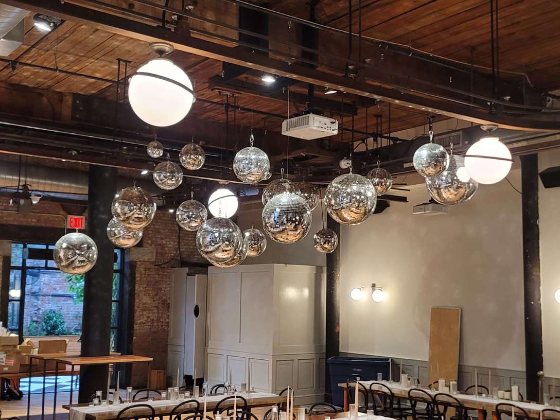 A cluster of Disco Balls (a.k.a. Mirror Balls) suspended above the dance floor inside The Wythe Hotel.