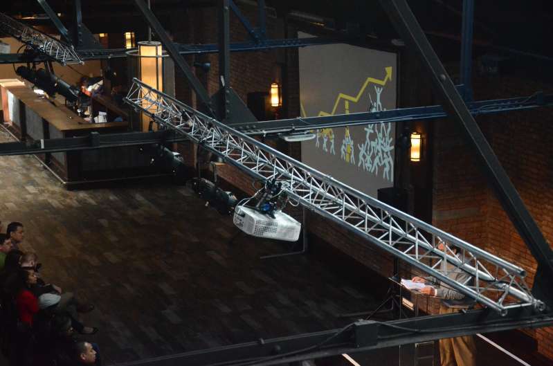 A Projector suspended overhead from a Truss with a screen mounted on the wall, and additional AV equipment was provided for a corporate event hosted at 26 Bridge in Brooklyn, NY.