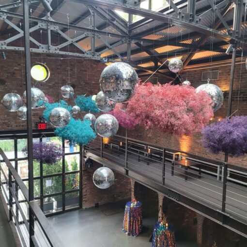 A cluster of disco balls at a wedding reception hosted at The Foundry in NYC. Florals provided and suspended by A Garden Party Florist.