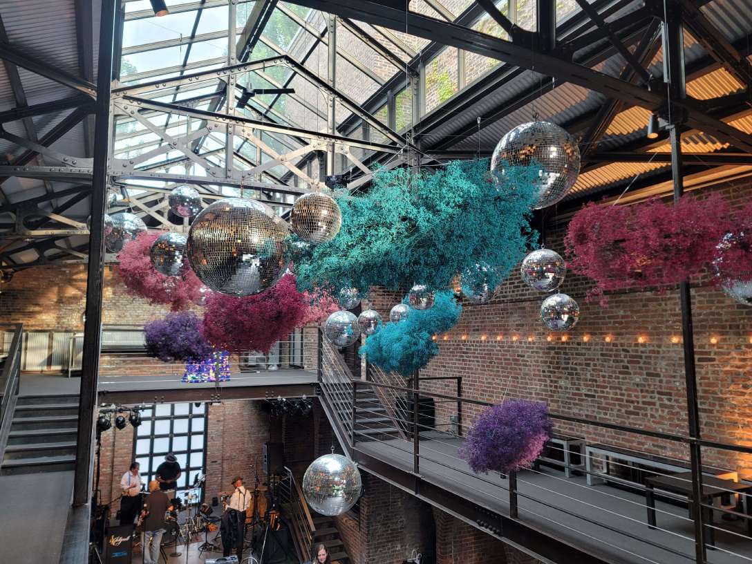 A cluster of disco balls at a wedding reception hosted at The Foundry in NYC. Florals provided and suspended by A Garden Party Florist.