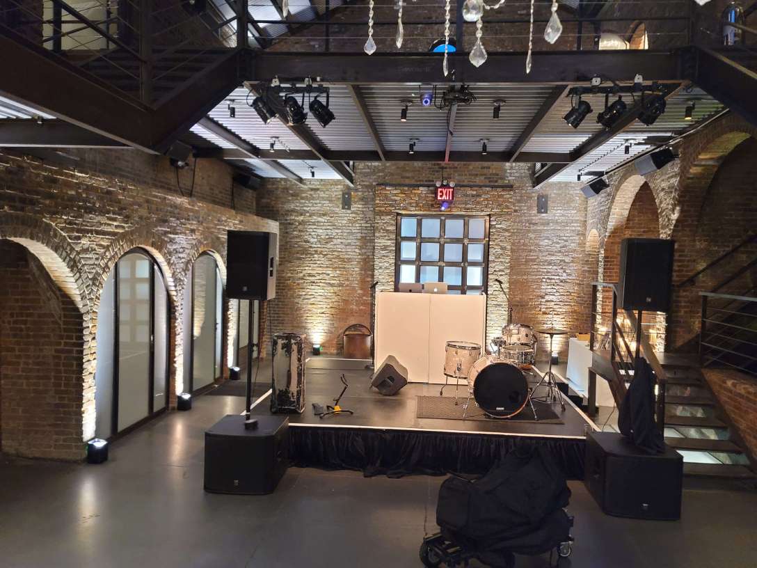 12ft x 12ft stage in the main room at the foundry with Up-Lights along the perimeter walls