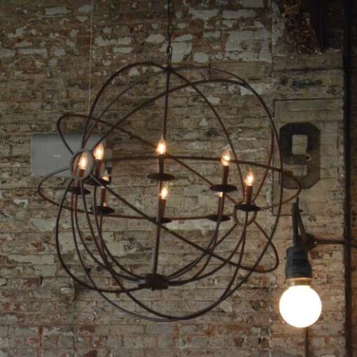 Bronze orb chandeliers hanging above the dinner tables for a wedding at The Houston Hall