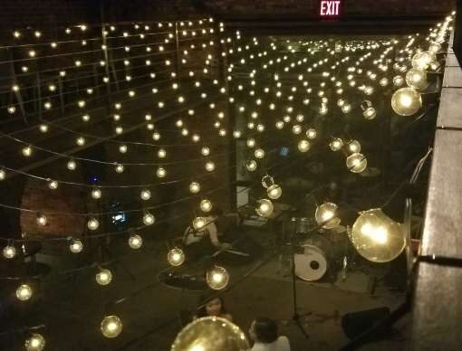 A Canopy of String Lights with warm white G50 bulbs hanging in the main room for a wedding at The Foundry.