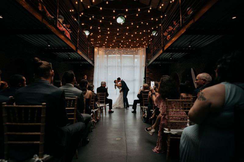 A canopy of String Lights with warm white G50 bulbs suspended in the main room for a wedding at The Foundry in Long Island City, NY.