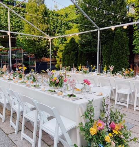 White String Lights with round G50 bulbs suspended from a tent frame in the courtyard for a wedding at The Foundry.