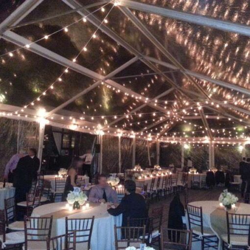 White String Lights (Bistro/Cafe Lights) with round G50 bulbs zigzagging under a tent in the courtyard for a wedding at The Foundry.