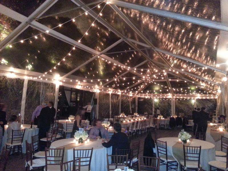 White String Lights (Bistro/Cafe Lights) with round G50 bulbs zigzagging under a tent in the courtyard for a wedding at The Foundry.