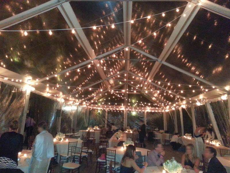 White String Lights with round G50 bulbs zigzagging under a tent in the courtyard for a wedding at The Foundry.