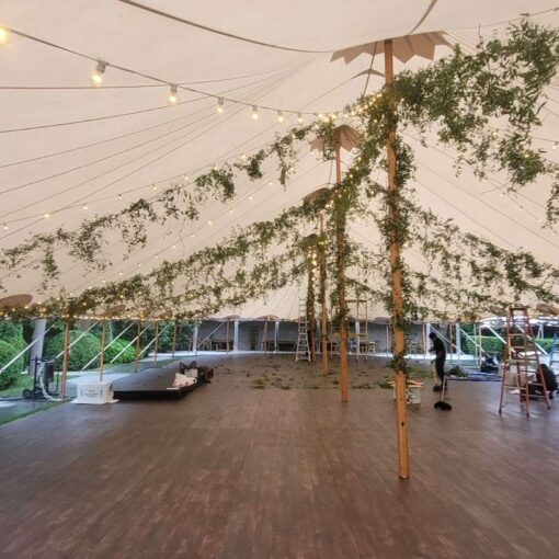 String Lights and Florals hanging under a sailcloth tent for a wedding reception at The Valley Rock Inn & Mountain Club located in Sloatsburg, NY.