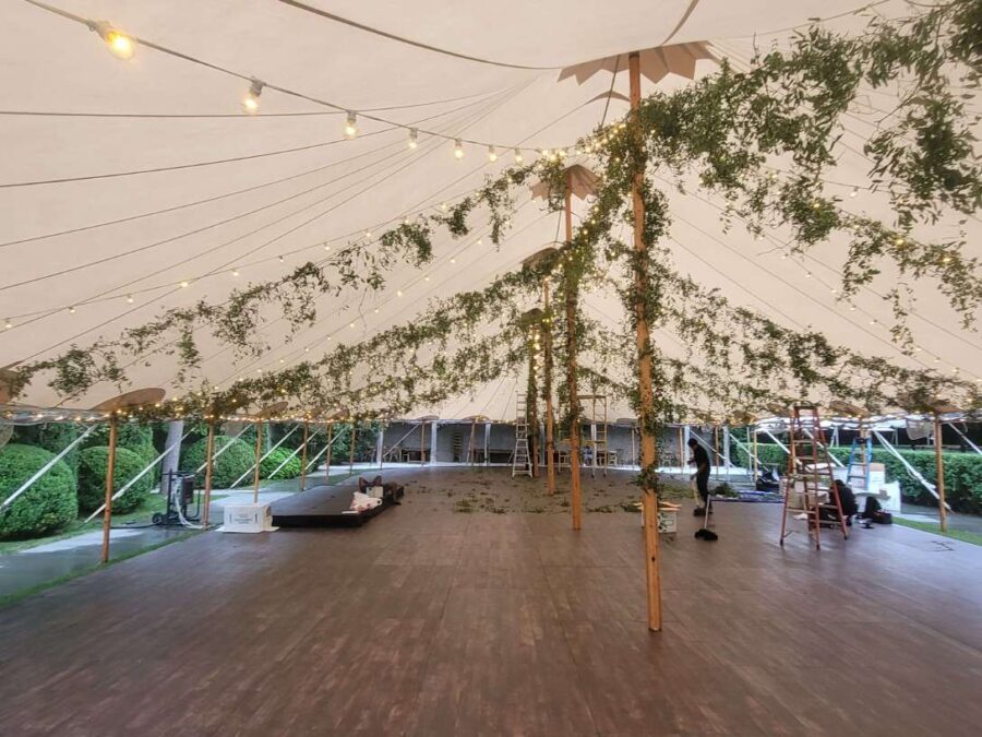 String Lights and Florals hanging under a sailcloth tent for a wedding reception at The Valley Rock Inn & Mountain Club located in Sloatsburg, NY.
