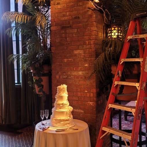 A Warm White Wash focused on a live band and ceremony for a wedding at The Bowery Hotel (New York, NY). A pinspot focused on a wedding cake.