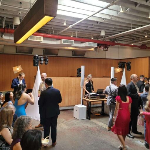Intelligent Lighting for the dance floor at a wedding at Rule of Thirds in Brooklyn, NY, featuring scanners and mini moving head wash lighting fixtures hanging from a pair of lighting stands covered with decorative white spandex.