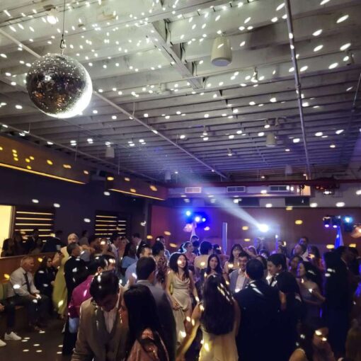Intelligent Lighting for the dance floor at a wedding at Rule of Thirds in Brooklyn, NY, featuring a mirror ball illuminated by a moving head beam.