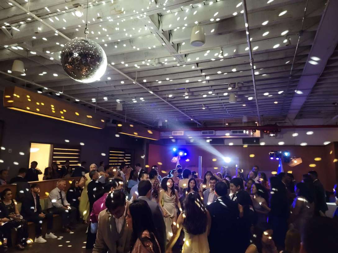Intelligent Lighting for the dance floor at a wedding at Rule of Thirds in Brooklyn, NY, featuring a mirror ball illuminated by a moving head beam.