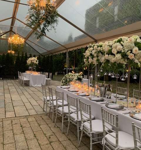 A 24" and 40" Crystal Chandelier suspended under a clear top tent in the courtyard for a wedding at The Foundry (Long Island City, NY).