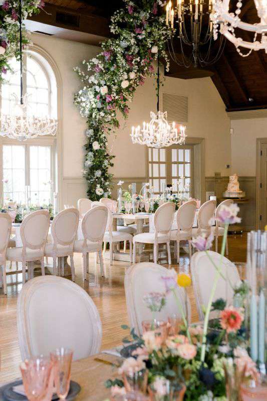 40" Crystal Chandeliers suspended low over dinner tables for a wedding at The Old Field Club (Setauket, NY).