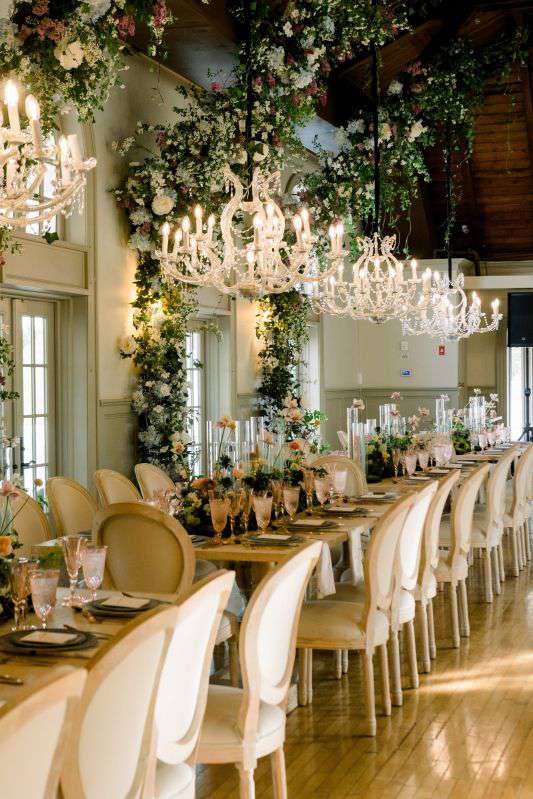 40" Crystal Chandeliers suspended low over dinner tables for a wedding at The Old Field Club (Setauket, NY).