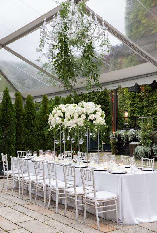 A 40" Crystal Chandelier suspended under a clear top tent in the courtyard for a wedding at The Foundry (Long Island City, NY).