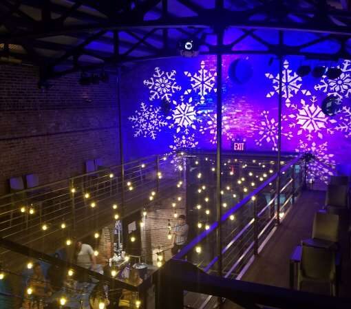 Main Room at The Foundry: String Lights suspended in a random zigzagging pattern along with a stock gobo and color-changing wash projected against the upper walls and ceiling.
