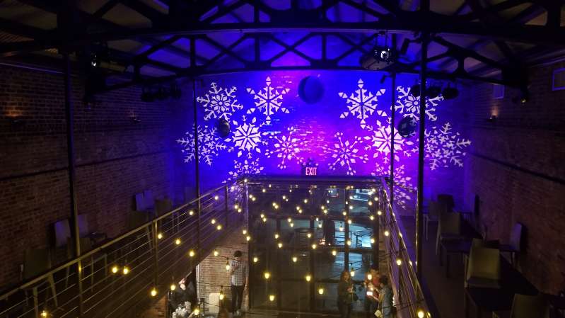 Main Room at The Foundry: String Lights suspended in a random zigzagging pattern along with a stock gobo and color-changing wash projected against the upper walls and ceiling.