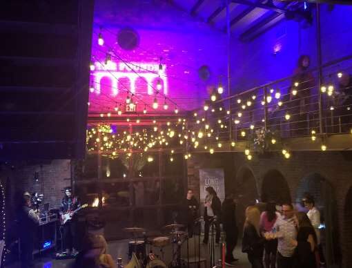 Main Room at The Foundry: String Lights suspended in a random zigzagging pattern along with custom gobo and color-changing wall projected against the upper walls and ceiling.