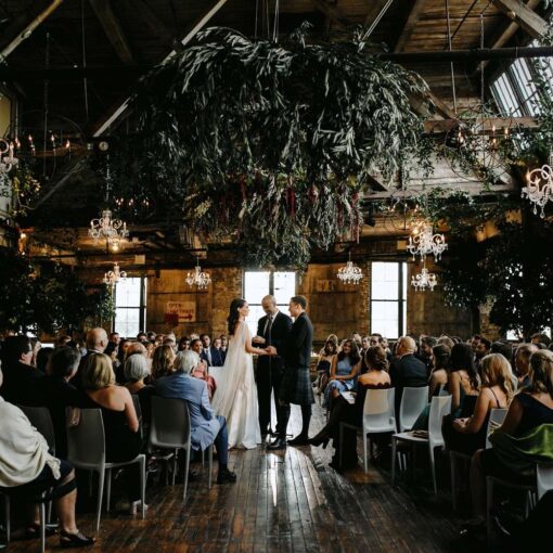 Bronze Orb Chandeliers and Venetian Chrystal Chandeliers hanging at a wedding in The Greenpoint Loft.