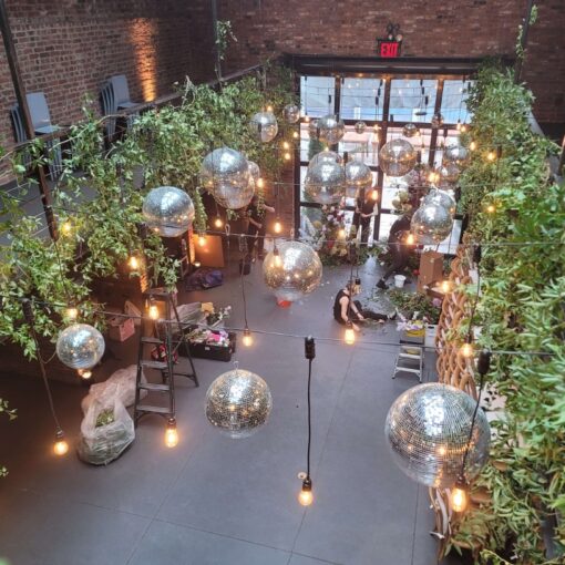 A cluster of mirror balls suspended with pendant lamps above the main floor at The Foundry.