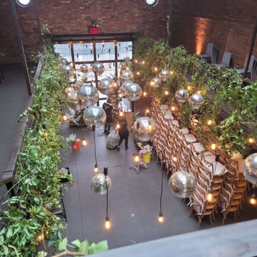 A cluster of mirror balls suspended with pendant lamps above the main floor at The Foundry.