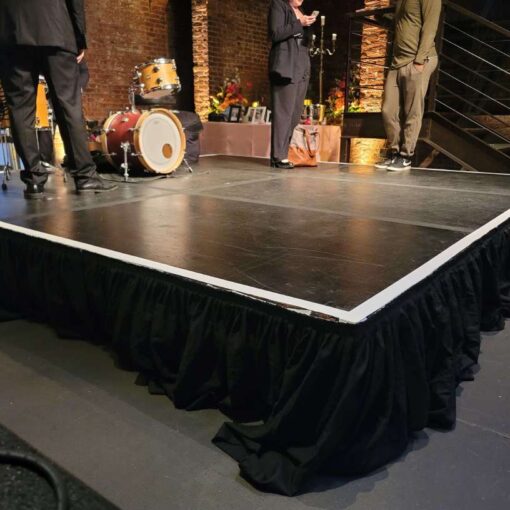 A 12ft x 12ft stage in the main room under the mezzanine level near the entrance doors at The Foundry.