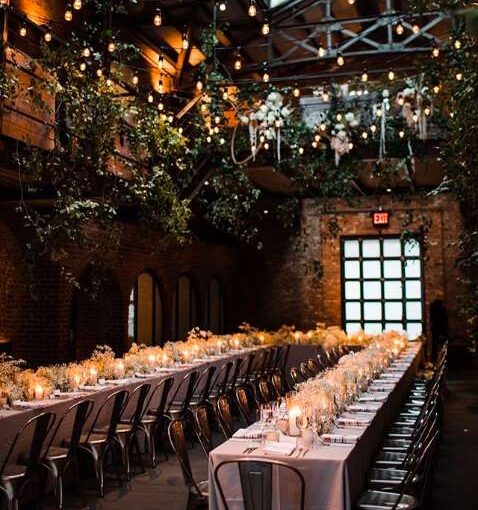 String Lights with warm white bulbs and hanging greenery overhead in the Main Room at The Foundry.