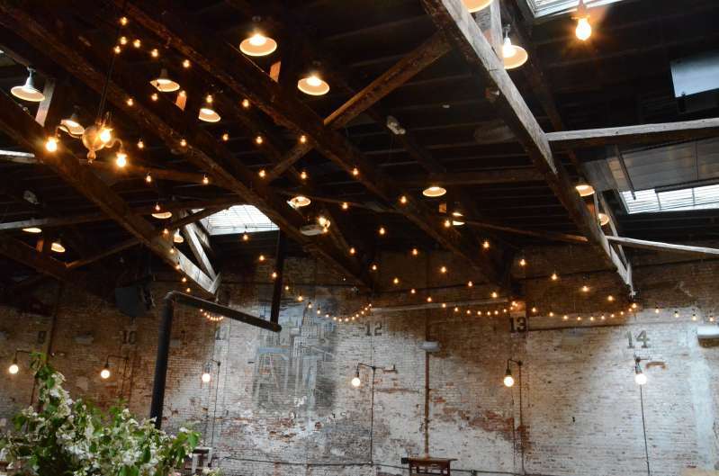 String Lights with warm white S14 bulbs hanging in a V-shaped pattern for a wedding at The Houston Hall