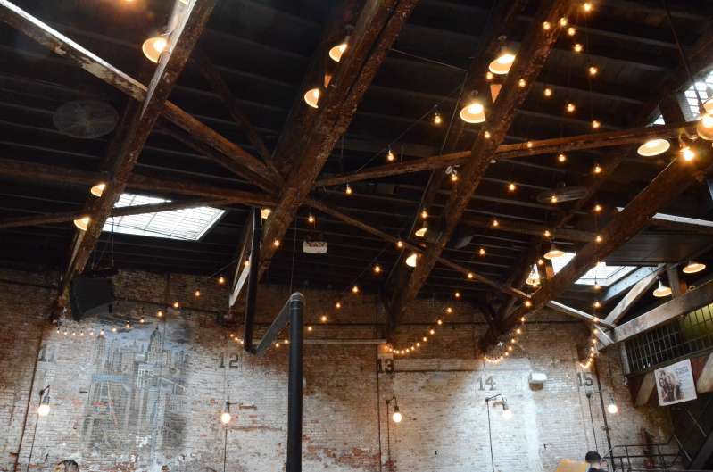 String Lights with warm white S14 bulbs hanging in a V-shaped pattern for a wedding at The Houston Hall