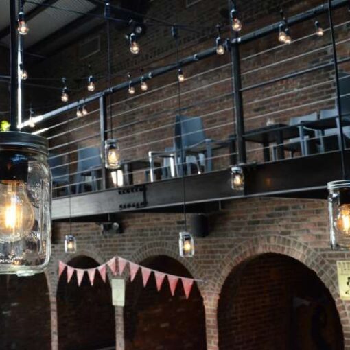Pendant Lamps with Mason Jars hanging in the main room at The Foundry for a wedding.