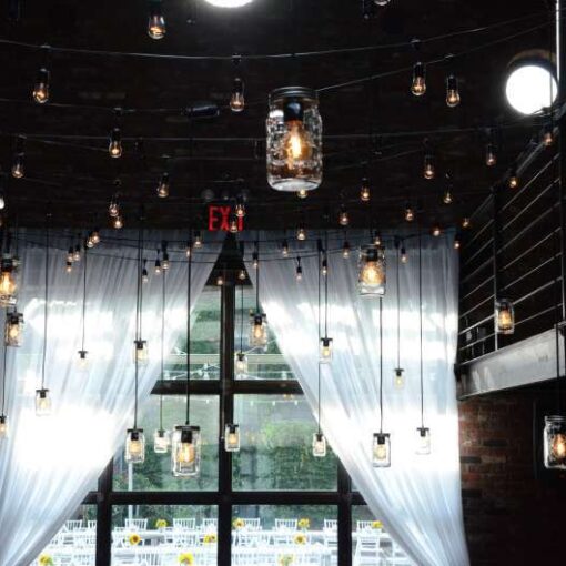 Pendant Lamps with Mason Jars hanging in the main room at The Foundry for a wedding.