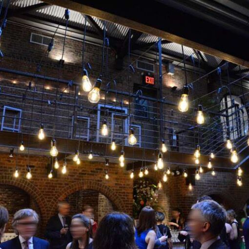 Warm White Pendant Lamps hanging in the main room at The Foundry across the mezzanine level for a wedding.