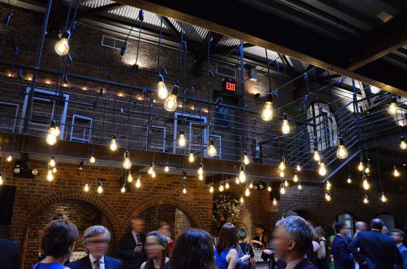 Warm White Pendant Lamps hanging in the main room at The Foundry across the mezzanine level for a wedding.