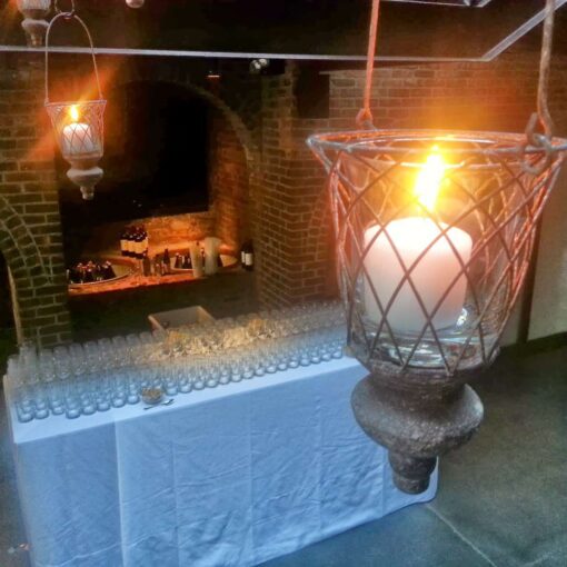 Lanterns with candles hanging in the main room for a wedding at The Foundry.