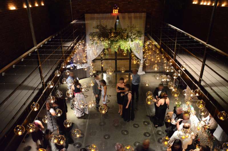 Round glass balls hanging across the mezzanine level for a wedding in The Main Room at The Foundry.