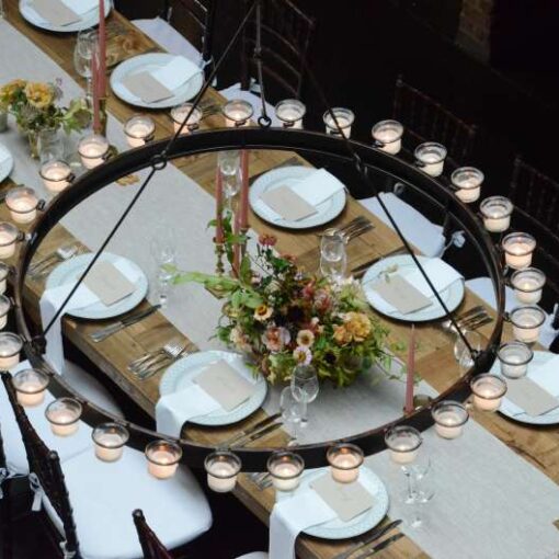Circular Chandeliers with Votive Candles hanging across the mezzanine level for a wedding in The Main Room at The Foundry.