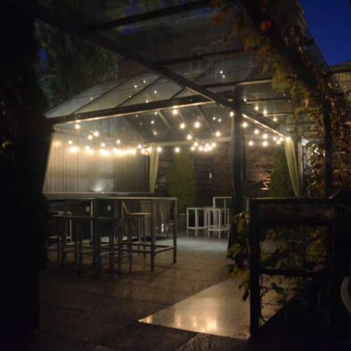 Warm White String Lights hanging in a zig zag pattern above the terrace for a wedding at The Foundry.