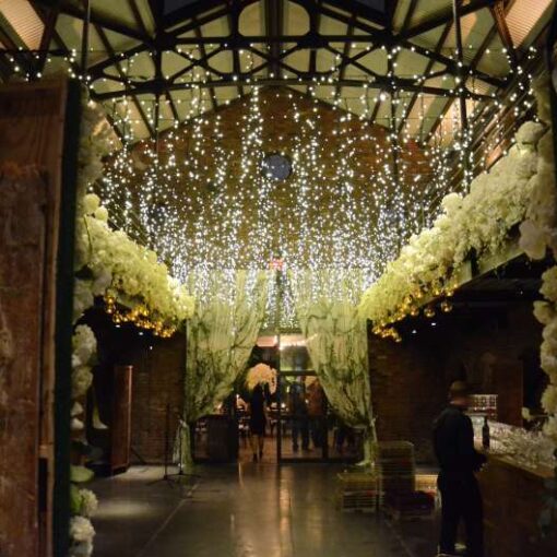 Fairy (Icicle) Lights hanging in the main room across the mezzanine level in the main room for a wedding at The Foundry.