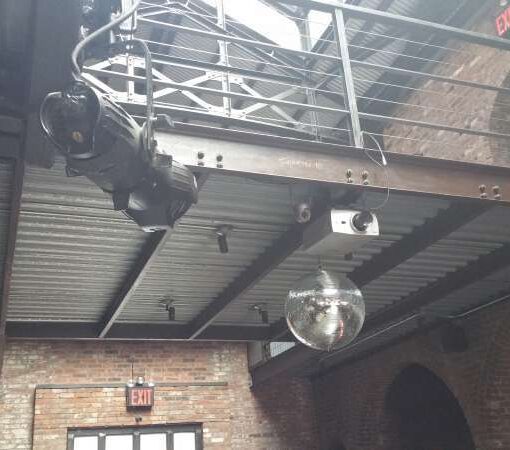 Mirror Ball with a motor and spotlight hanging in the main room for a wedding at The Foundry.