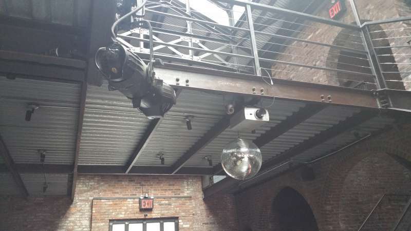 Mirror Ball with a motor and spotlight hanging in the main room for a wedding at The Foundry.