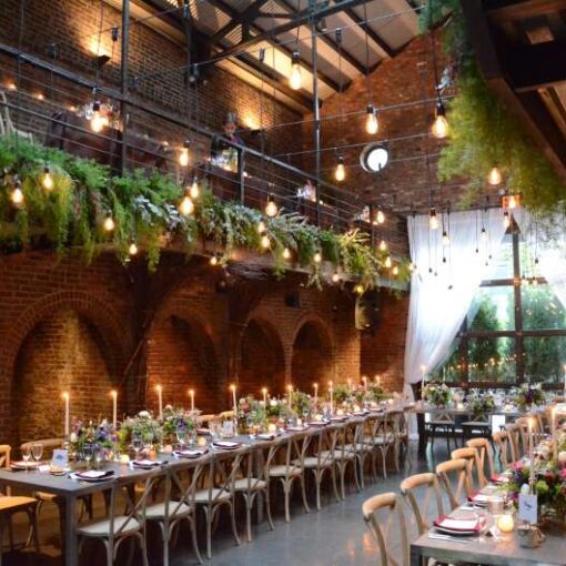 Pendant Lamps with Antique Edison bulbs are hanging in the main room at The Foundry for a wedding.