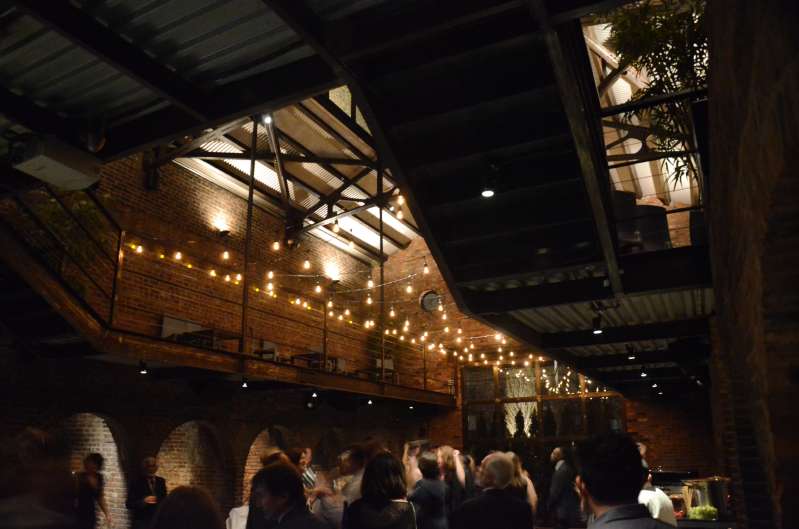 Warm White zigzagging string lights hanging in the main room for a fundraising event at The Foundry.
