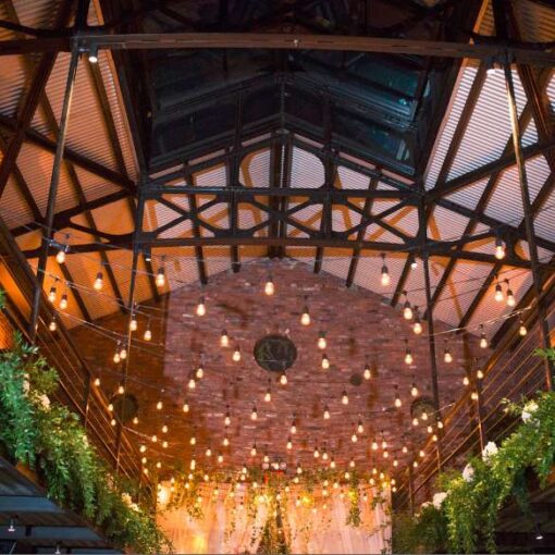 Warm White zigzagging string lights hanging in the main room for a Wedding at The Foundry.