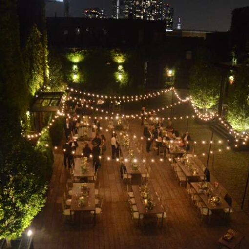 String Lights hanging outdoors from lighting stands above the courtyard at The Foundry.