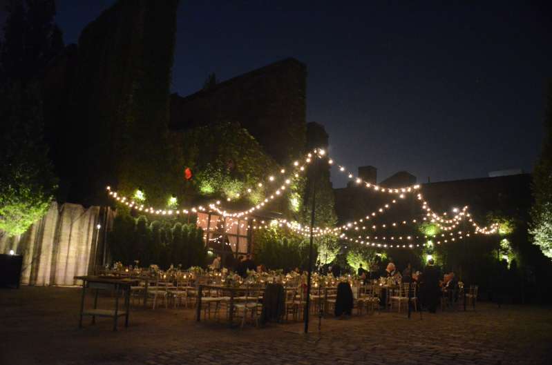 String Lights hanging outdoors from lighting stands above the courtyard at The Foundry.