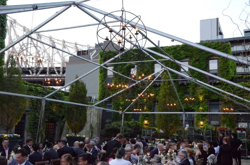 Orb Chandeliers hanging under a raw tent frame in the courtyard for a wedding at The Foundry.